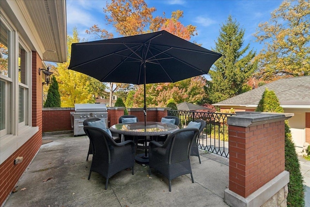 view of patio with outdoor dining area and grilling area