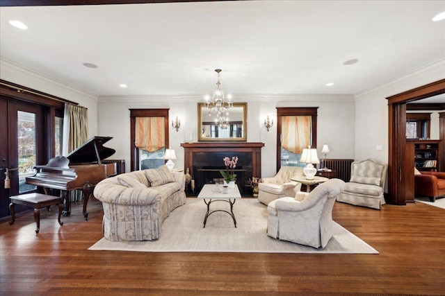 living room with recessed lighting, radiator, a notable chandelier, and wood finished floors