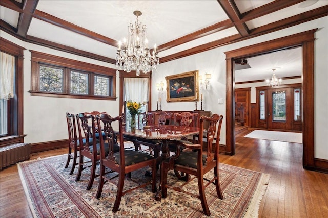 dining area featuring a chandelier, baseboards, and hardwood / wood-style floors