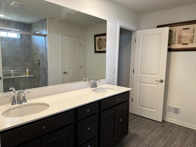 full bath with wood finished floors, visible vents, and a sink