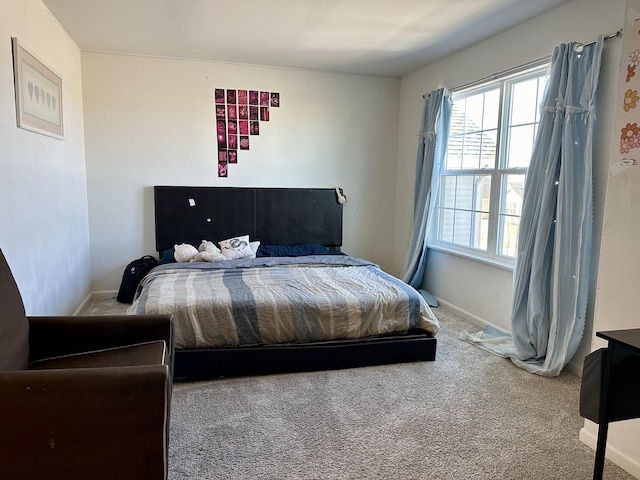 carpeted bedroom featuring baseboards