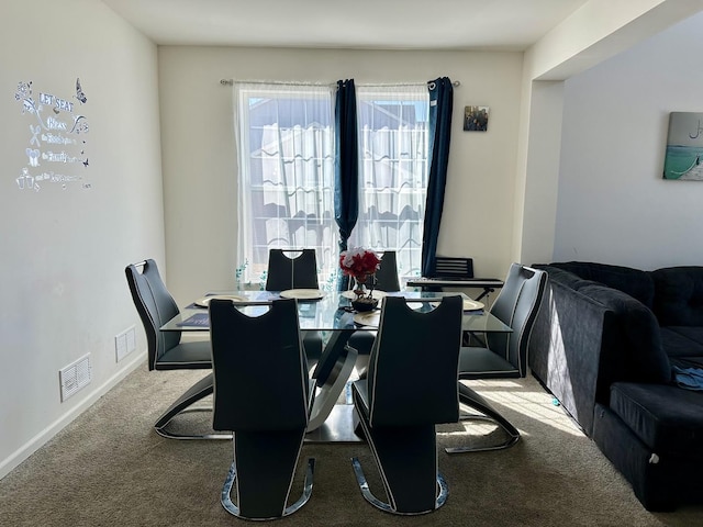 dining space with visible vents, baseboards, and carpet