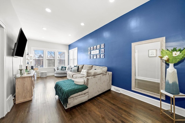 living room with hardwood / wood-style floors, visible vents, recessed lighting, and baseboards