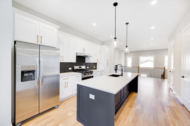 3502 S Union Ave, Chicago, IL 60609 - kitchen with stainless steel appliances, a sink, under cabinet range hood, a kitchen island with sink, and white cabinetry