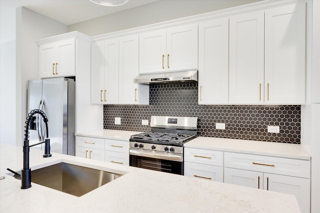 3502 S Union Ave, Chicago, IL 60609 - kitchen with appliances with stainless steel finishes, under cabinet range hood, a sink, white cabinets, and tasteful backsplash