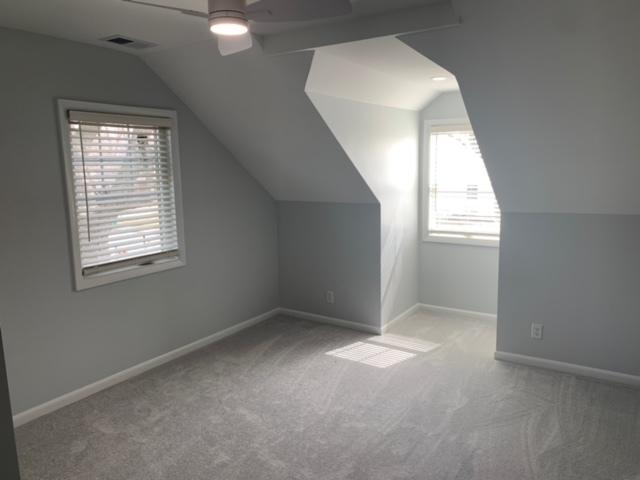 1613 Jones St, Joliet, IL 60435 - additional living space featuring healthy amount of natural light, carpet flooring, lofted ceiling, and a ceiling fan