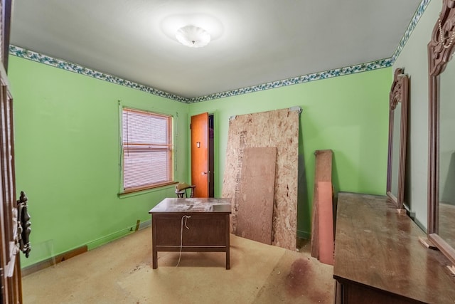 office featuring baseboards and concrete floors