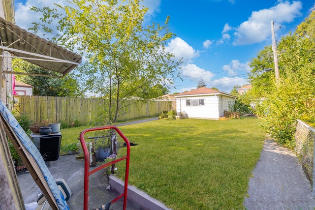 view of yard with an outdoor structure and a fenced backyard