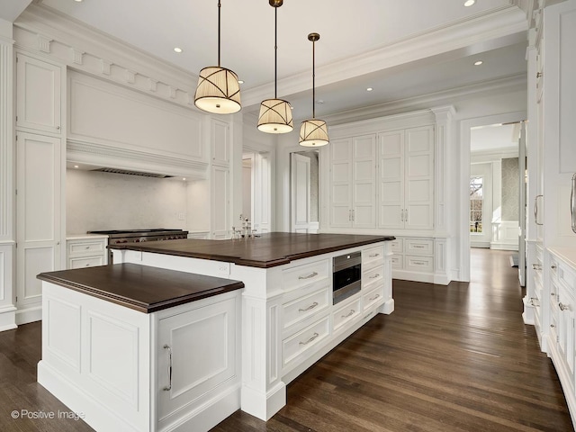 330 S County Line Rd, Hinsdale, IL 60521 - kitchen with butcher block counters, a decorative wall, stainless steel microwave, white cabinetry, and crown molding