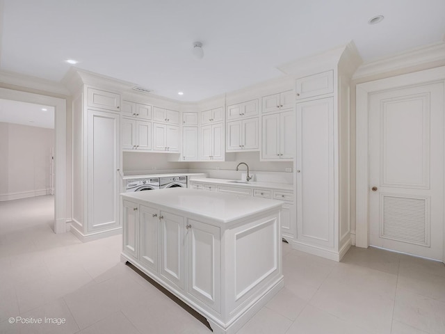 330 S County Line Rd, Hinsdale, IL 60521 - kitchen with a sink, light countertops, white cabinetry, a kitchen island, and light tile patterned floors