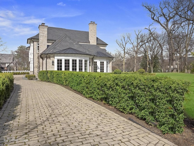 330 S County Line Rd, Hinsdale, IL 60521 - back of property with a chimney, a standing seam roof, and metal roof