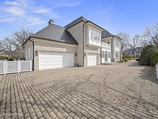 330 S County Line Rd, Hinsdale, IL 60521 - view of property exterior featuring decorative driveway, a chimney, and a garage