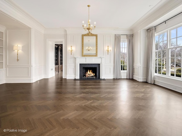 330 S County Line Rd, Hinsdale, IL 60521 - unfurnished living room featuring a chandelier, a decorative wall, a high end fireplace, and ornamental molding