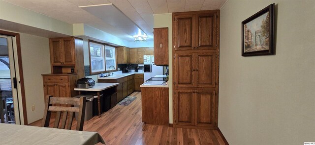 508 N Fayette, Carthage, IL 62321 - kitchen featuring a sink, brown cabinetry, and light wood-style floors