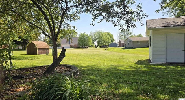 508 N Fayette, Carthage, IL 62321 - view of grassy yard with a storage shed and an outdoor structure