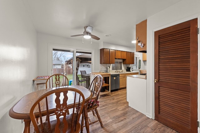 dining area featuring light wood finished floors and ceiling fan