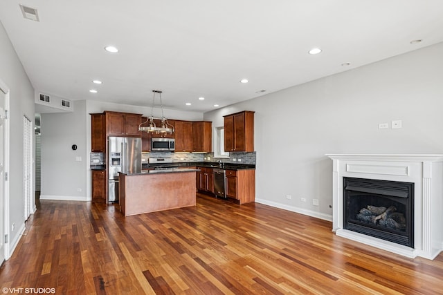 7170 W Grand Ave Unit 3E, Chicago, IL 60707 - kitchen featuring tasteful backsplash, dark countertops, visible vents, dark wood finished floors, and stainless steel appliances