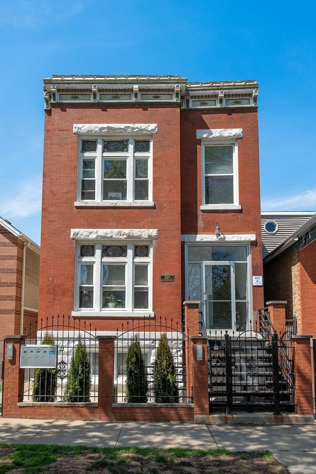 1304 N Campbell Ave, Chicago, IL 60622 - view of front of property featuring brick siding, a gate, and a fenced front yard