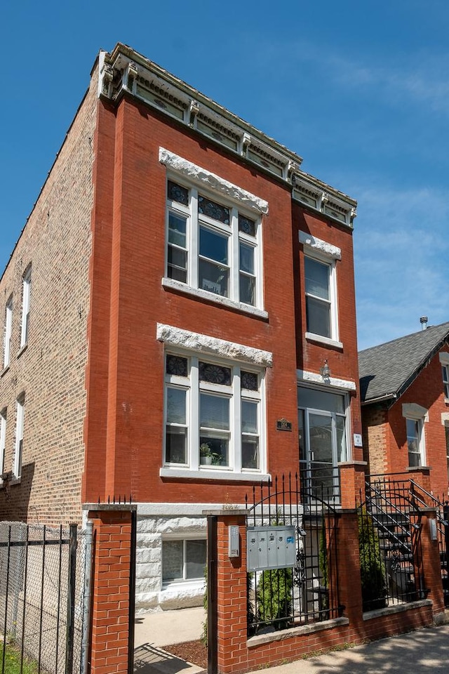 1304 N Campbell Ave, Chicago, IL 60622 - view of front facade with brick siding and a fenced front yard