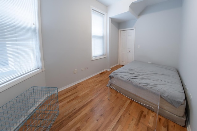 1304 N Campbell Ave, Chicago, IL 60622 - bedroom with baseboards, multiple windows, and light wood finished floors