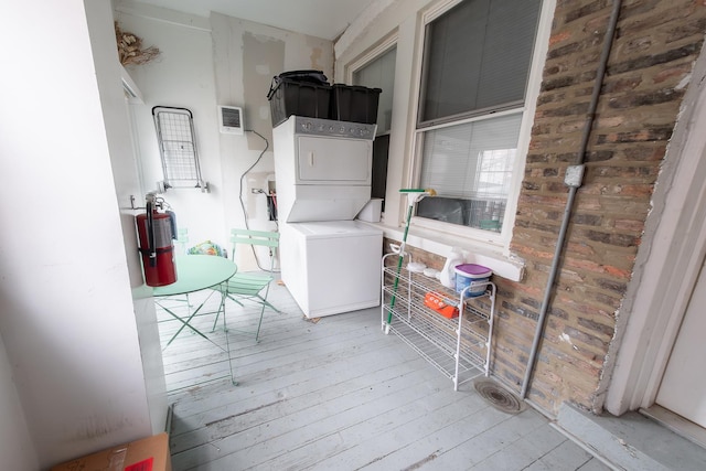 1304 N Campbell Ave, Chicago, IL 60622 - clothes washing area with laundry area, stacked washer and clothes dryer, and light wood-style flooring