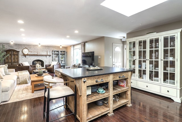 kitchen featuring dark wood-style floors, dark countertops, recessed lighting, open shelves, and a kitchen island
