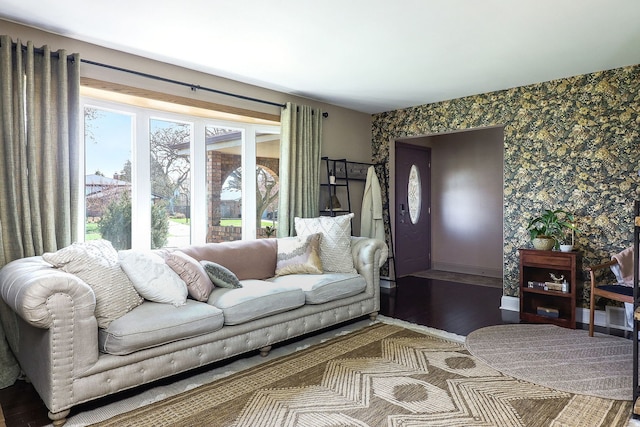 living area featuring wallpapered walls and wood finished floors