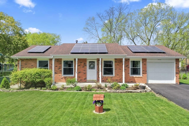 23610 N Overhill Dr, Lake Zurich, IL 60047 - single story home featuring an attached garage, brick siding, roof mounted solar panels, and a front yard