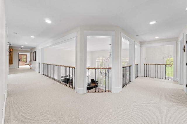 corridor featuring recessed lighting, plenty of natural light, and carpet floors