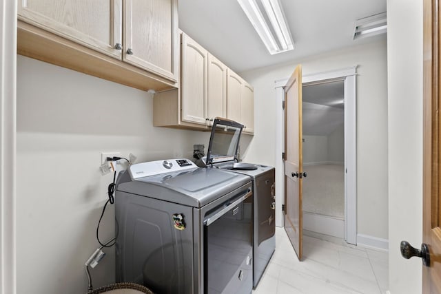 laundry area with separate washer and dryer, cabinet space, baseboards, and marble finish floor