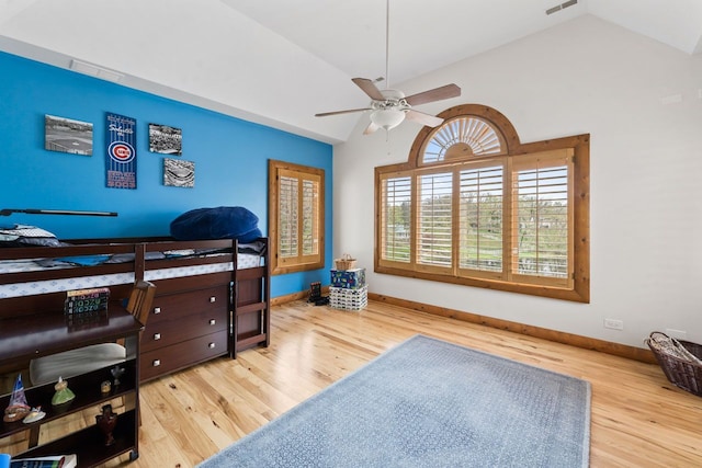 bedroom featuring wood finished floors, visible vents, baseboards, ceiling fan, and lofted ceiling