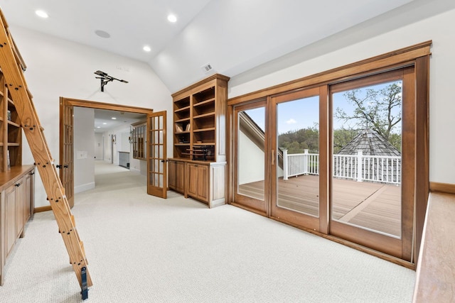 interior space with french doors, visible vents, light colored carpet, vaulted ceiling, and recessed lighting