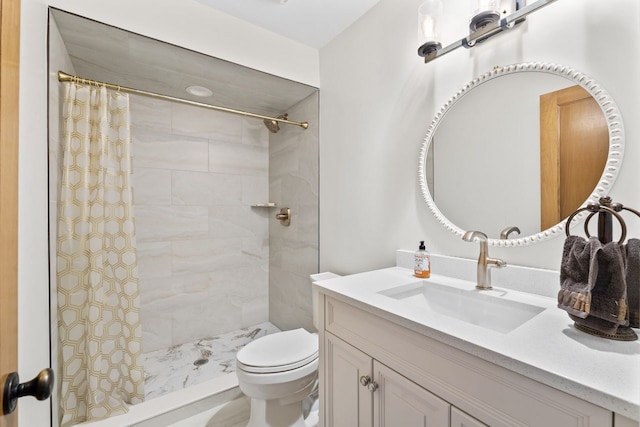 bathroom with toilet, tiled shower, and vanity