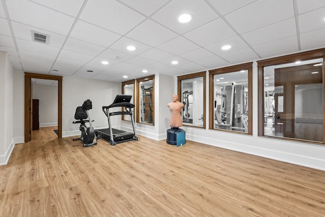 exercise room with visible vents, wood finished floors, baseboards, and recessed lighting