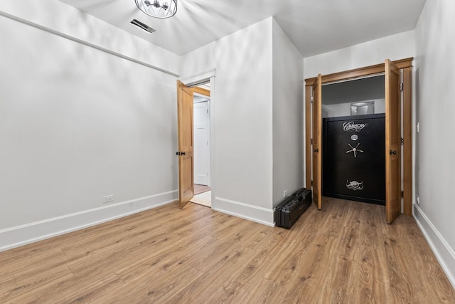 unfurnished bedroom with light wood-style flooring, baseboards, and visible vents