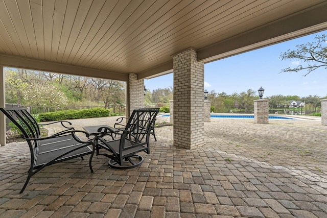 view of patio / terrace featuring fence and an outdoor pool