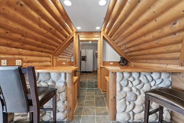 10 Old Hart Rd, Barrington Hills, IL 60010 - bar featuring stone tile floors, recessed lighting, log walls, and stainless steel fridge