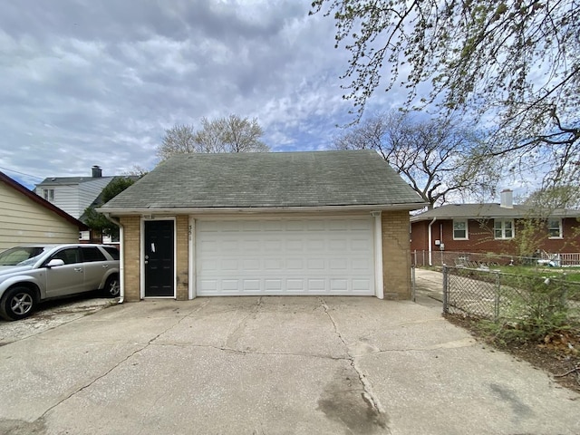 351 Clyde Ave, Calumet City, IL 60409 - view of front facade with a garage, brick siding, fence, and an outbuilding