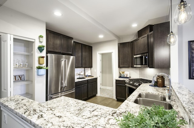 kitchen with high quality appliances, a sink, light stone counters, recessed lighting, and dark brown cabinetry