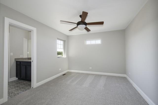 carpeted spare room with baseboards and ceiling fan