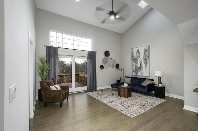 living area featuring dark wood-style floors, baseboards, high vaulted ceiling, and ceiling fan