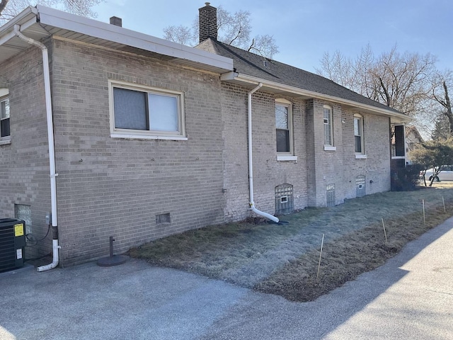 651 Douglas Ave, Calumet City, IL 60409 - view of side of home with central AC, a chimney, and brick siding
