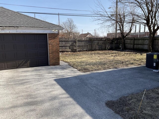 651 Douglas Ave, Calumet City, IL 60409 - view of yard featuring an outdoor structure, fence, cooling unit, and a garage