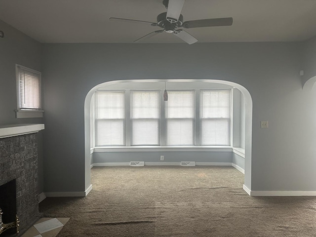 651 Douglas Ave, Calumet City, IL 60409 - interior space featuring arched walkways, carpet flooring, a ceiling fan, and plenty of natural light