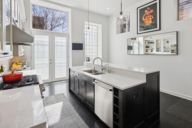 kitchen with light countertops, a sink, dark cabinets, french doors, and stainless steel dishwasher