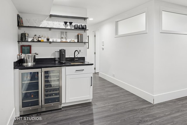 bar with recessed lighting, baseboards, dark wood-style floors, beverage cooler, and indoor wet bar