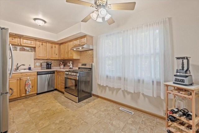 602 S Vista Dr, Algonquin, IL 60102 - kitchen with stainless steel appliances, under cabinet range hood, a sink, light countertops, and tasteful backsplash