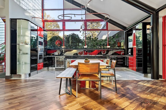 dining room with wine cooler, a high ceiling, and wood finished floors