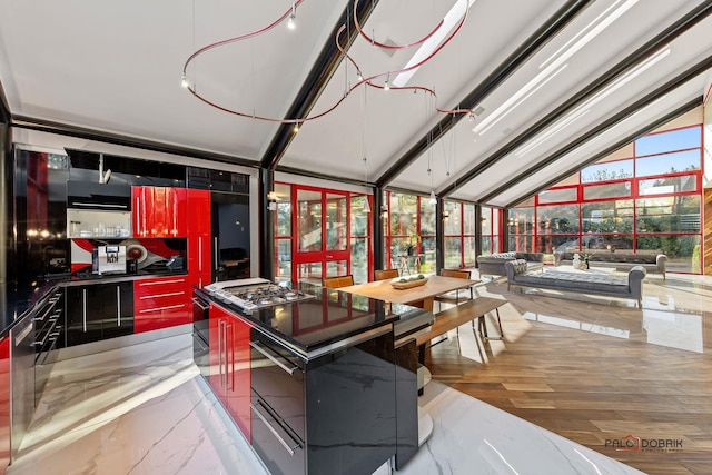 kitchen with dark countertops, stainless steel gas stovetop, marble finish floor, modern cabinets, and a warming drawer