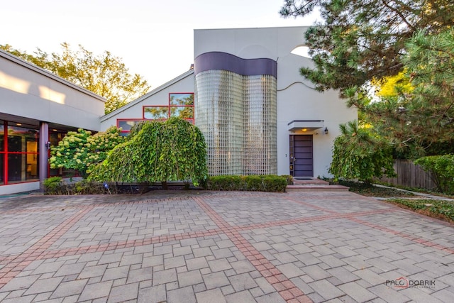 exterior space featuring fence and stucco siding